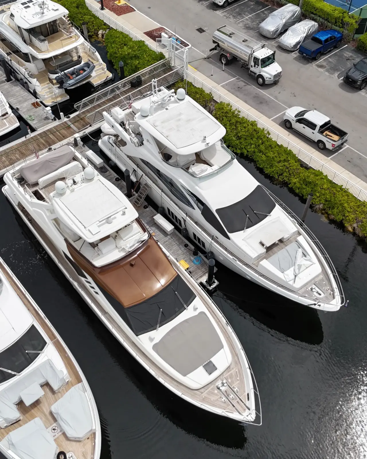 Exigo Fuels delivery truck refueling a yacht in South Florida Exigo Fuels delivery truck serving luxury yacht at South Florida marina - Professional fuel delivery services